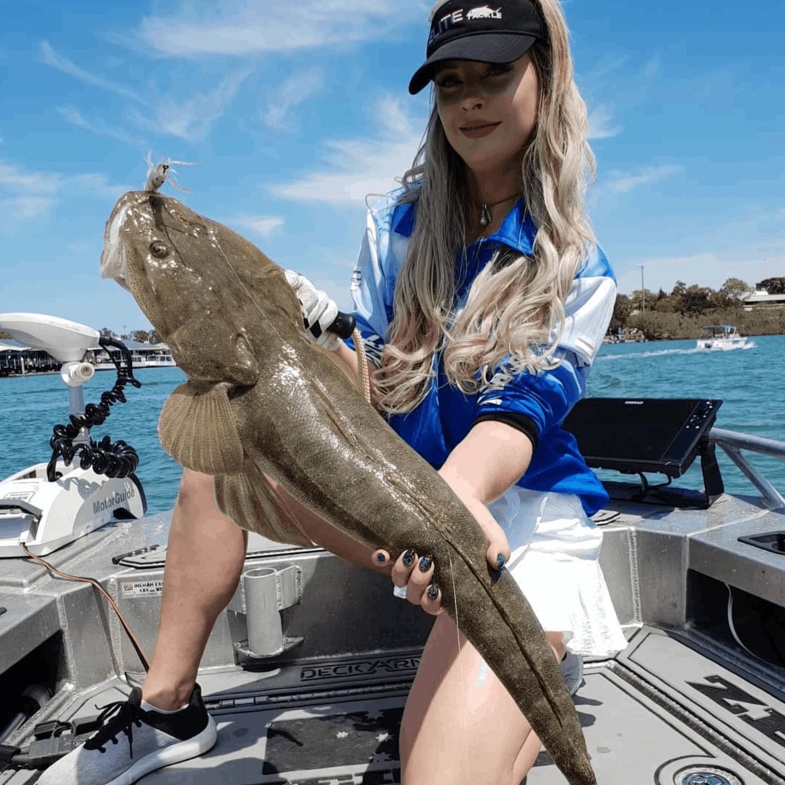 Angler holding a flathead caught on a Chasebaits lure