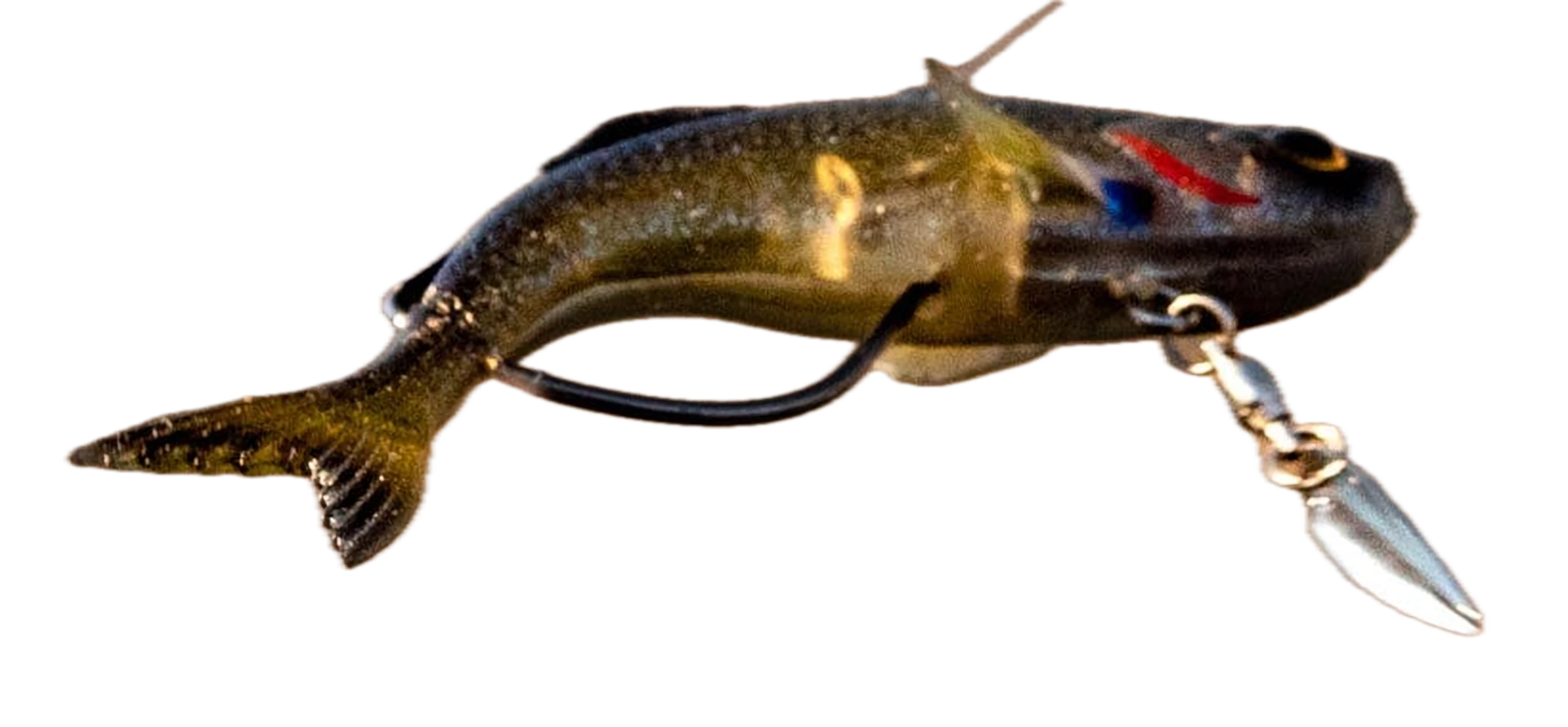 A swimbait in mid-cast over the river